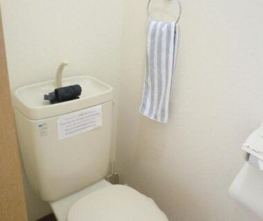 Small restroom with tank-top sink and striped towel at Hotobil B&B in Nara