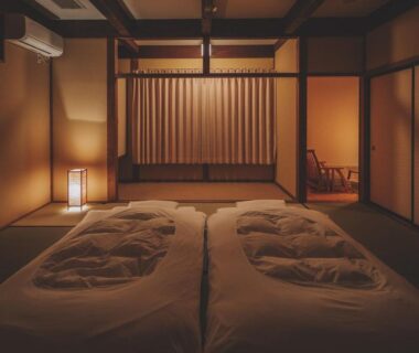 Low-lit tatami room with futons and shoji screens at Hotorinite in Yamanashi