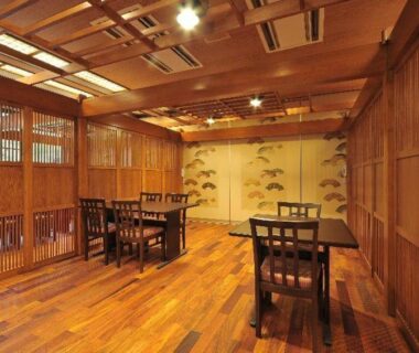 Wooden interior dining area with lattice screens at Houshi Onsen Chojukan, Gunma, Kanto