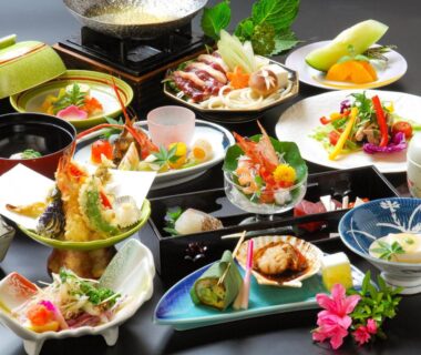 Assorted Japanese multi-course dishes including sashimi, tempura, bowls and colorful garnishes