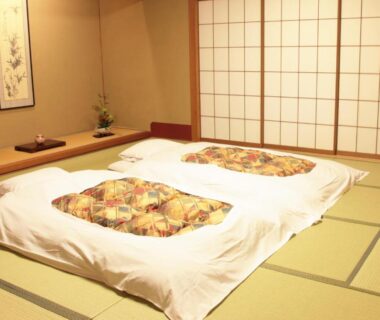 Two futons on tatami mats with shoji screens and a tokonoma alcove at Hyoe Koyokaku in Hyōgo