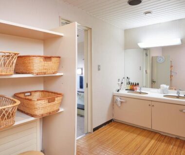 Dressing area with wicker baskets and double sinks at IKOI Villa Nagano