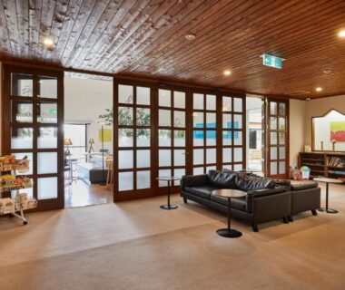 Lobby with leather sofas, wooden ceiling and shoji-style doors at IKOI Villa in Nagano, Chūbu