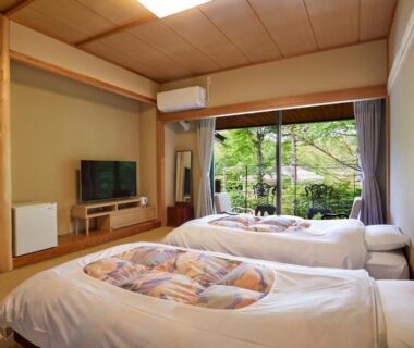 Tatami room with two beds and garden view at IKOI Villa in Nagano