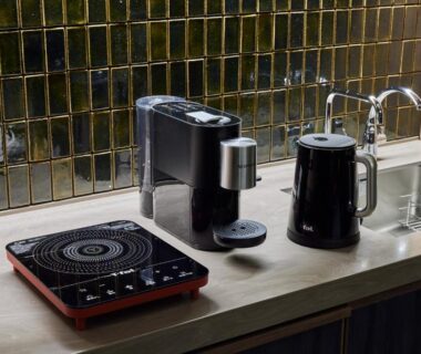 Compact kitchenette with electric kettle, coffee maker, induction cooktop and sink at ITSUKUSHIMA IROHA, Hiroshima