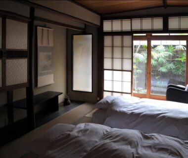 Tatami room with two futons and shoji doors at IZUYASU Traditional Kyoto Inn, Kyoto
