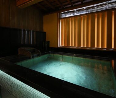 Onsen bath with wooden panels and soft lighting at Ichidaya in Hyōgo, Kansai