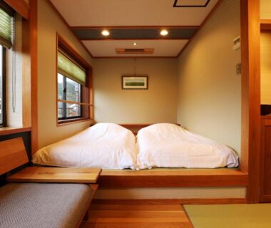 Raised tatami alcove with twin futons and wooden interior at Ichidaya in Hyōgo, Kansai, Japan