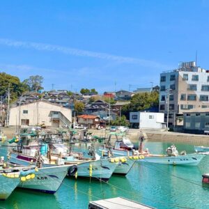 Small fishing boats moored in turquoise harbor near Ichifukuso in Saga, Kyūshū