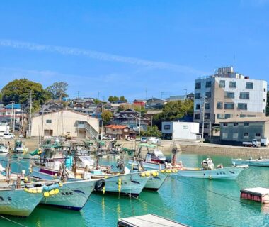 Small fishing boats moored in turquoise harbor near Ichifukuso in Saga, Kyūshū