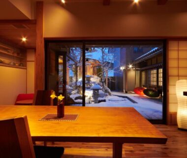 Wooden dining table and shoji screens overlooking snowy courtyard at Ichinomatsu Japanese Modern Hotel Gifu Chubu