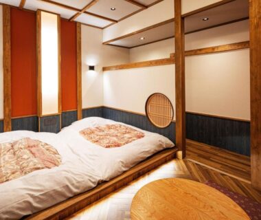 Raised wooden room with futon bedding and low table at Ichinoyu Honkan, Kanagawa, Kantō