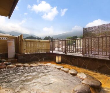 Stone-lined outdoor bath with mountain views at Ichinoyu Katei in Nagano, Chūbu