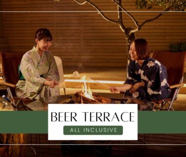 Two guests in yukata seated by outdoor fire on beer terrace at Ichiraku Tendo Spa & Brewery, Yamagata