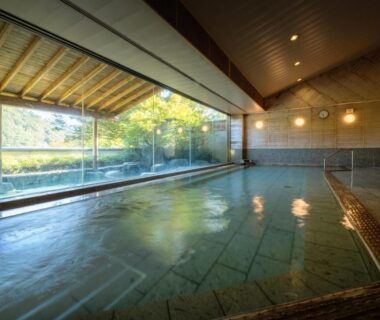 Spacious indoor onsen bath with panoramic garden view at Iizaka Onsen Surikamitei Ohtori, Fukushima