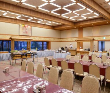 Large ryokan banquet hall with set tables and buffet area at Iizaka Onsen Surikamitei Ohtori, Fukushima