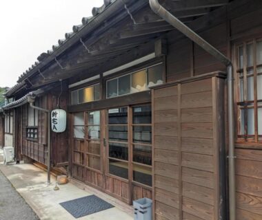 Exterior wooden facade with lattice windows and lantern at Iizukatei entrance, Tochigi, Kanto, Japan