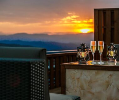 Outdoor terrace table with glasses and lanterns at sunset overlooking distant mountains, Ijika Daiichi Hotel Kagura, Mie