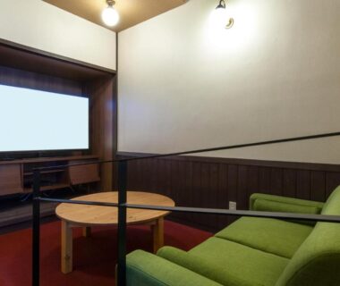 Green sofa and round wooden table seating area at Ikaho Syusuien in Gunma, Kantō