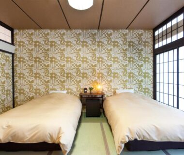 Tatami room with twin beds and shoji screens at Ikaho Syusuien in Gunma, Kantō