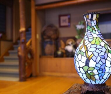 Stained glass lamp on wooden table in Ikariya Ryokan lobby, Nagano Chūbu