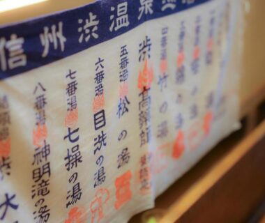 Cloth sign with Japanese onsen names at Ikariya Ryokan, Nagano