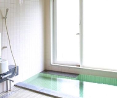 Tiled indoor bath with window and wash area at Ikoiso, Hokkaidō, Japan