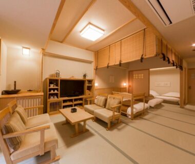 Tatami room with futon beds, low table, chairs and shoji screens at Ikyu reopening in Mie, Kansai