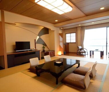 Tatami room with low table and floor cushions, balcony seating at Inatori Tokai Hotel Yuen, Shizuoka