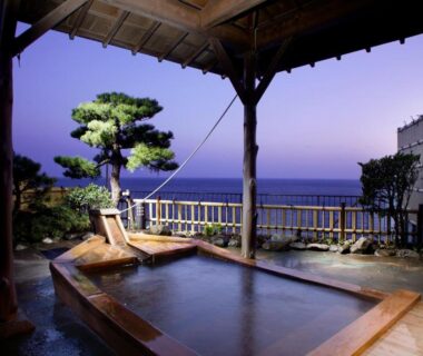 Covered wooden outdoor onsen bath with coastal view at Inatori Tokai Hotel Yuen, Shizuoka