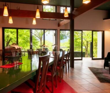 Dining area with long table, pendant lights and garden views at Innter Hill Tsubasa Yufuin, Ōita