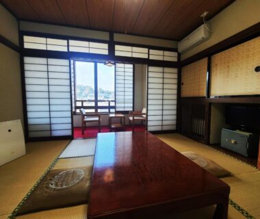 Traditional tatami room with low table, shoji screens and balcony seating at Iris Yu in Iwate