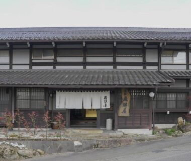Two-story traditional wooden ryokan exterior with entrance noren at Iroriyado Hidaya in Gifu, Chūbu, Japan