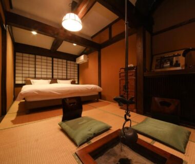 Tatami room with irori hearth, two beds and shoji screens at Iroriyado Hidaya, Gifu, Chūbu