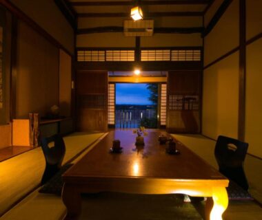 Traditional tatami room with low wooden table and shoji screens at Isamikan in Tochigi