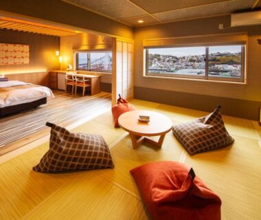 Spacious tatami guest room with low table and cushions at Isaribinoyado Seaside Kancho in Wakayama, Kansai
