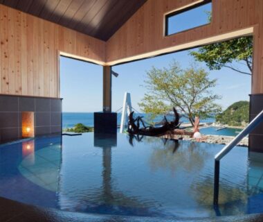 Indoor hot spring bath with panoramic sea view at Isaribinoyado Seaside Kancho in Wakayama