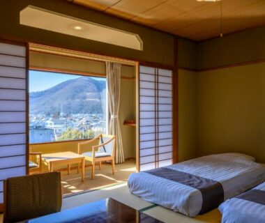 Sunlit tatami room with twin futons and low table at Isawa Tokiwa Hotel in Yamanashi Chubu