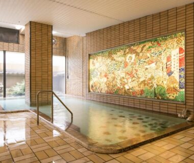 Indoor tiled onsen bath with decorative mural at Isawa Tokiwa Hotel in Yamanashi, Chūbu, Japan