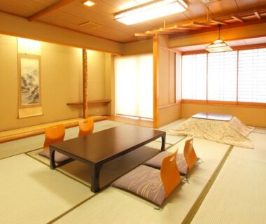 Tatami room with low table, zabuton cushions and shoji screens at Isawa View Hotel Yamanashi