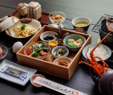 Assorted small dishes in wooden box with grilled seafood at Ise-Shima Ohtaya in Mie Japan