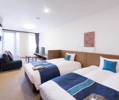 Bright twin room with two beds, sofa and balcony at Isegekusando Iseshinsen Mie