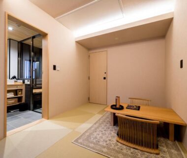 Tatami room with low table and adjacent wash area at Ishibekoji Muan Kyoto