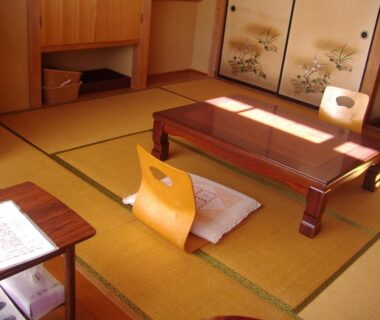 Traditional tatami room with low table, zabuton cushions and painted fusuma at Ishibu-so in Shizuoka