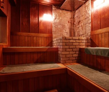 Wooden sauna with tiered benches and brick heater at Issinkan ryokan, Tochigi, Kantō, Japan