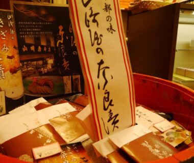 Assorted wrapped snacks and souvenirs arranged in a wooden basket at Itaniya ryokan in Nara, Kansai