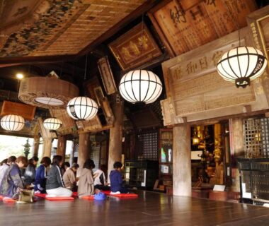Spacious wooden hall with round lanterns and floor cushions at Itaniya, Nara, Kansai, Japan