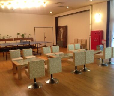 Spacious ryokan lounge with low tables and upholstered chairs at Itaniya, Nara, Kansai