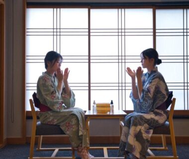 Two guests in yukata seated by shoji screens with small table at Ito Kowakien Shizuoka