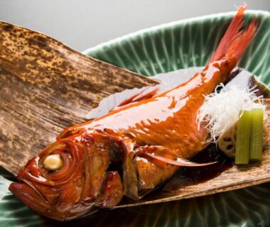 Glazed whole fish on leaf-lined ceramic plate at Ito Ryokuyu, Shizuoka, Chūbu, Japan